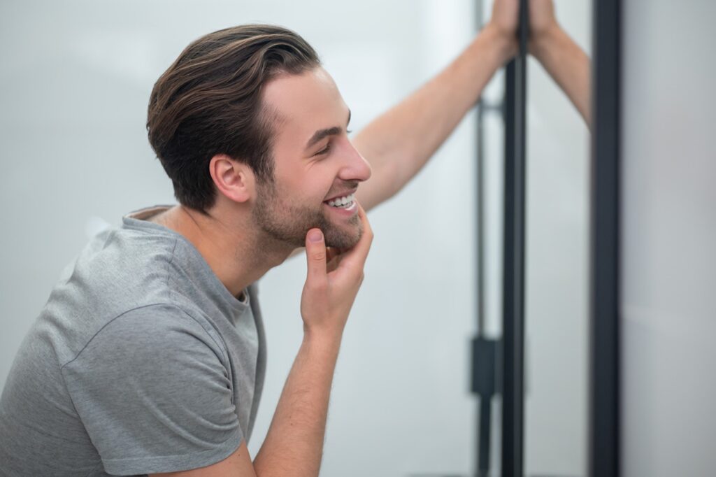 appearance-young-man-grey-tshirt-looking-his-reflection-mirror