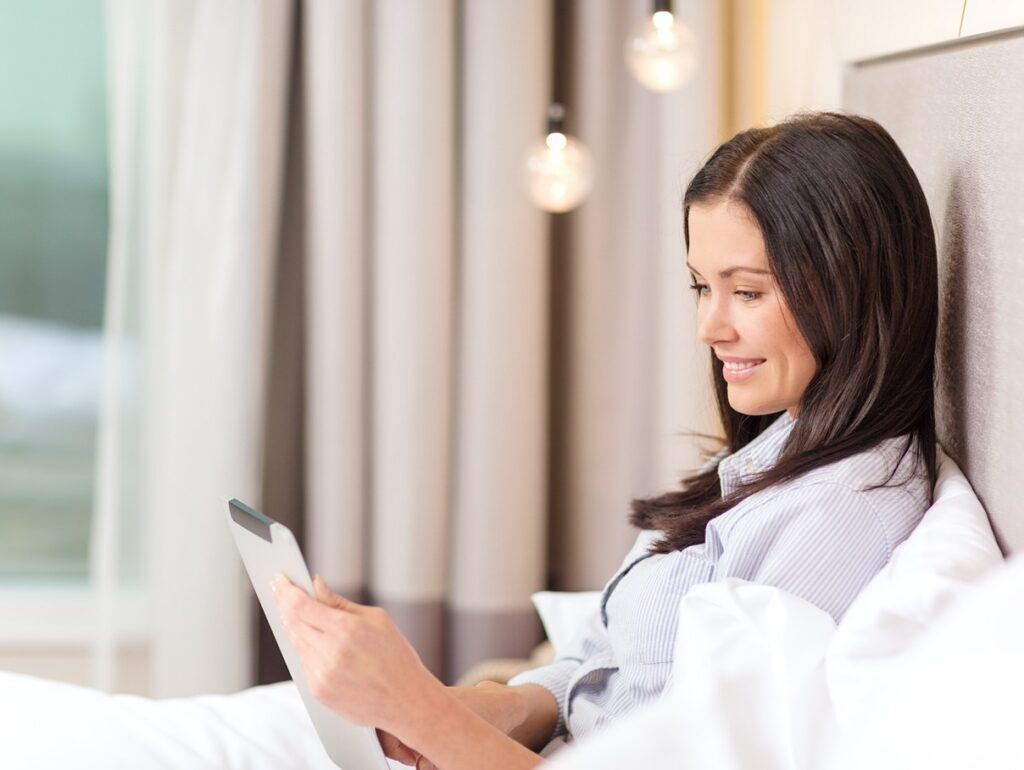 business-technology-internet-hotel-concept-happy-businesswoman-with-tablet-pc-computer-lying-hotel-bed