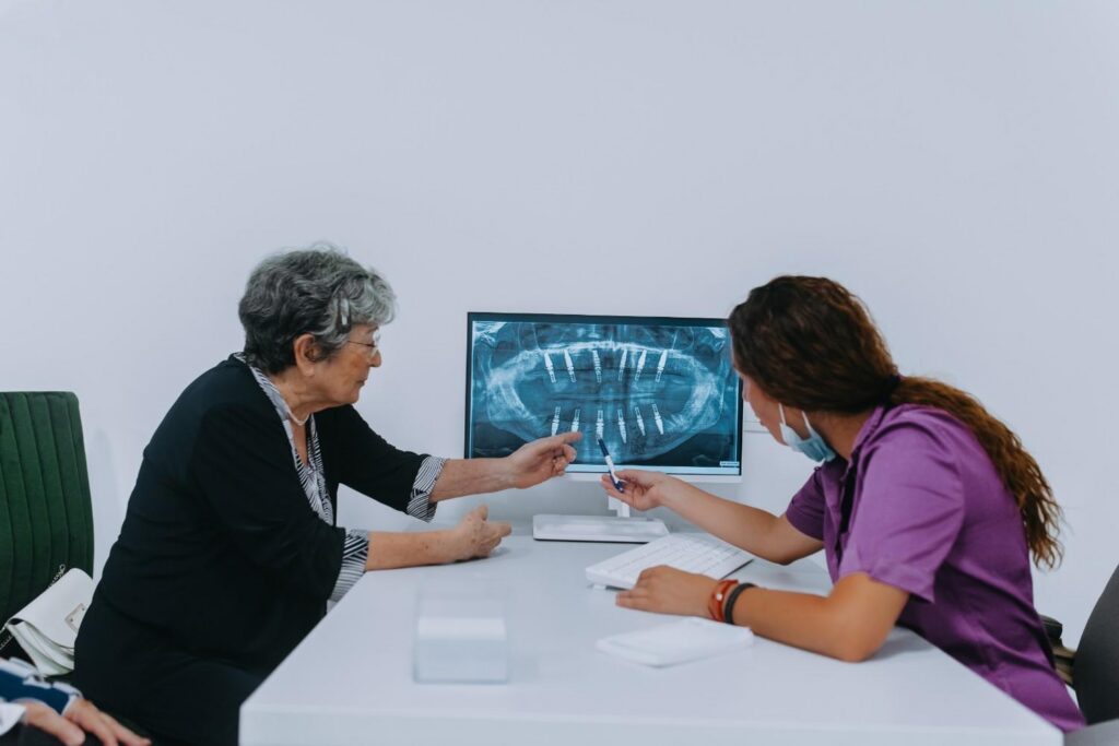 Patient discussing dental X-rays with a dentist.