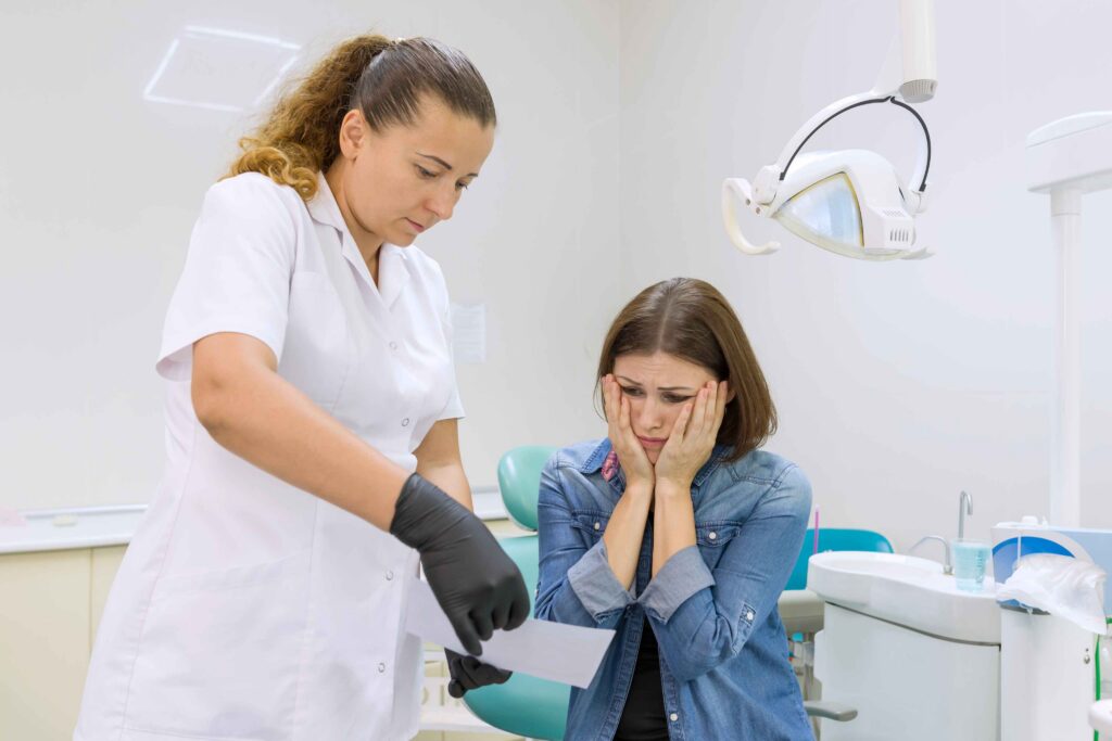 Concerned patient discussing a dental emergency with dentist