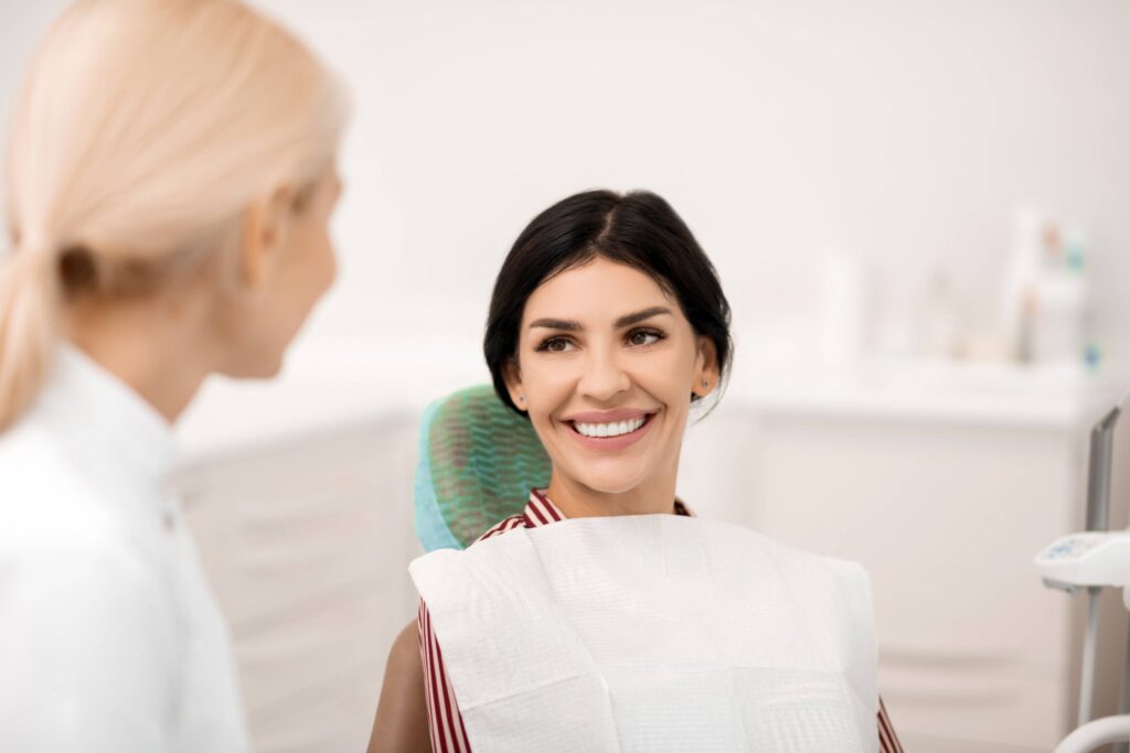 Smiling patient speaking with dentist during consultation