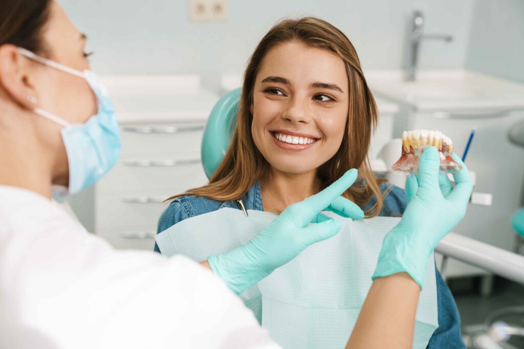 Dentist explaining oral health using a dental model